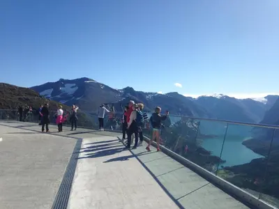 a group of people walking on the edge of a mountain at Arnestova - villagehouse in Loen in Loen