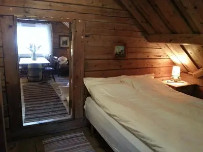 a bedroom with a bed in a wooden cabin at Arnestova - villagehouse in Loen in Loen