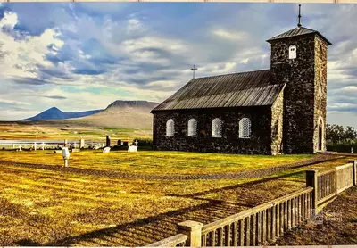 an old church in a field next to a fence at Family friendly apartment in Hafjell ski in-out, fireplace, sauna and wifi in Hafjell