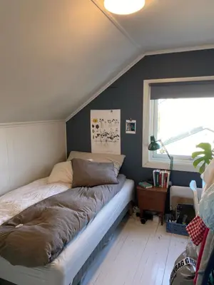 a bed in a room with a window at Small apartment with 4 bedrooms close to city in Trondheim