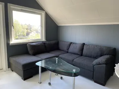 a living room with a couch and a glass table at Small apartment with 4 bedrooms close to city in Trondheim