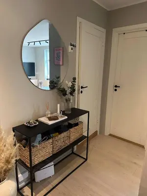 a bathroom with a mirror and a table with a sink at Apartment Lademoen Trondheim in Trondheim