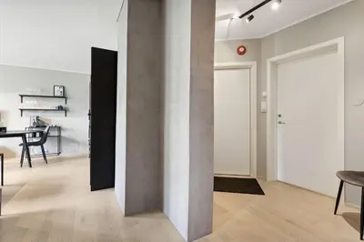 a living room with a door and a table at Apartment Lademoen Trondheim in Trondheim