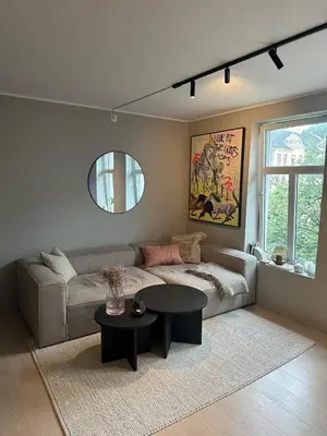 a living room with a couch and a table at Apartment Lademoen Trondheim in Trondheim