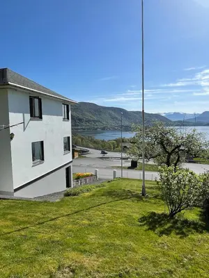 a white house with a view of a body of water at Retro hus med fin beliggenhet in Haddal