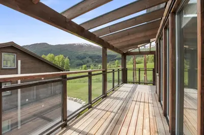 a large deck with a view of the mountains at Large nice apartment in Myrkdalen in Vossevangen