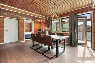 a dining room with a table and chairs at Large nice apartment in Myrkdalen in Vossevangen
