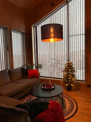 a living room with a couch and a christmas tree at New Apartment, Porch & Sauna, Sunnmøre Alps in Stranda