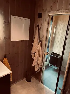a bathroom with a towel hanging on the wall at New Apartment, Porch & Sauna, Sunnmøre Alps in Stranda