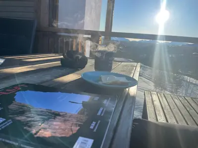 a table with a plate of food on top at New Apartment, Porch & Sauna, Sunnmøre Alps in Stranda