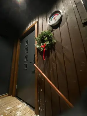 a door with a christmas wreath and a clock at New Apartment, Porch & Sauna, Sunnmøre Alps in Stranda