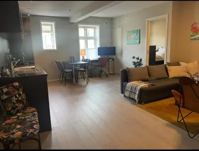 a living room with a couch and a table at Modern central apartment in a quiet area in Bergen