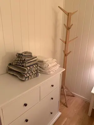 a pile of towels sitting on top of a dresser at Ski in-Ski out with Mountain View at Voss in Vossevangen