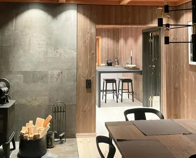 a room with a table and chairs and a kitchen at Nature-Close Cabin By Trysil Mountain in Trysil