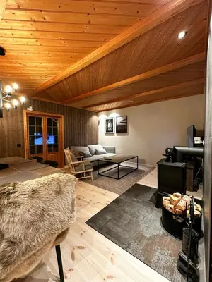 a living room with a couch and a table at Nature-Close Cabin By Trysil Mountain in Trysil