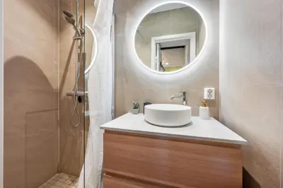 a bathroom with a sink and a mirror at Authentic Bergen Apartment in Bergen