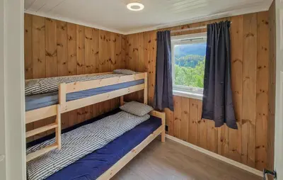a bedroom with two bunk beds and a window at Nice Home In Hafslo With Wifi in Hafslo