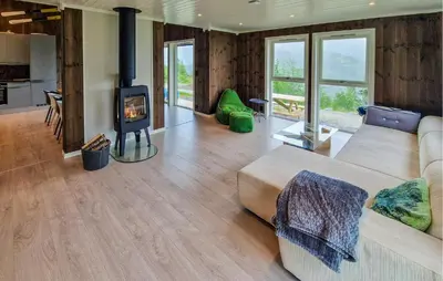 a living room with a couch and a wood stove at Nice Home In Hafslo With Wifi in Hafslo