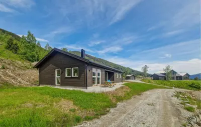 a small wooden house on a dirt road at Nice Home In Hafslo With Wifi in Hafslo
