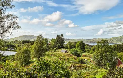 a view of a field with trees and a lake at Amazing Home In Frekhaug in Frekhaug