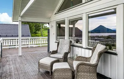 two chairs and a glass table on a porch at 3 Bedroom Amazing Home In Elnesvågen in Sylte