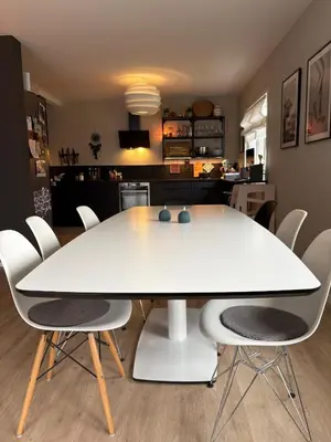 a white dining table and chairs in a room at Entire home with pool and garden in Ålesund