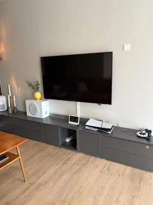 a living room with a large flat screen tv on the wall at Entire home with pool and garden in Ålesund