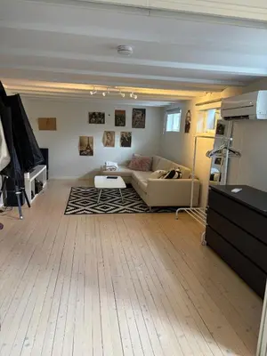 a living room with a couch and a table at Entire home with pool and garden in Ålesund