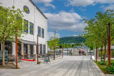 a street in front of a building with a ramp at Roomsly Apartments - City flat with Private Balcony in Bergen