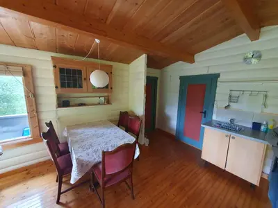 a kitchen with a table and chairs in a room at Feriehus Rodal med Båt in Rodal