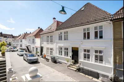 a street of white houses with cars parked on the street at Studio apartment centrally located in Bergen in Bergen