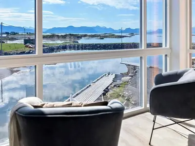 a living room with a large window looking out at the water at 8 person holiday home in Sandøy in Finnøy