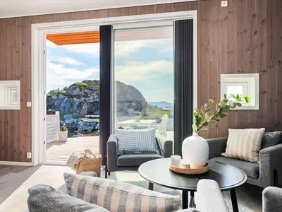 a living room with a couch and a table at 8 person holiday home in Sandøy in Finnøy