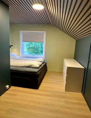 a small room with a bed and a window at Spacious holiday home by the fjord and mountains in Sæbø