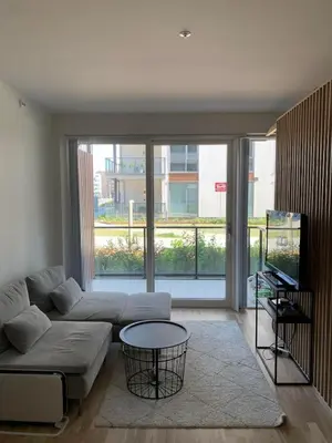 a living room with a couch and a table at New and modern apartment in Trondheim, Øvre Nyhavna in Trondheim
