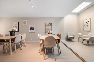 a room with tables and chairs and paintings on the wall at Central stay apartment - 201 in Bergen