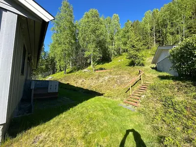 a shadow of a person standing next to a house at Family house near Kvitfjell & Hunderfossen in Fåvang