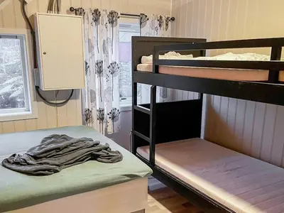 a room with two bunk beds and a window at 8 person holiday home in hauglandshella