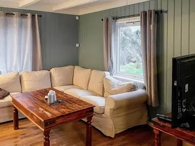 a living room with a couch and a table at 8 person holiday home in hauglandshella