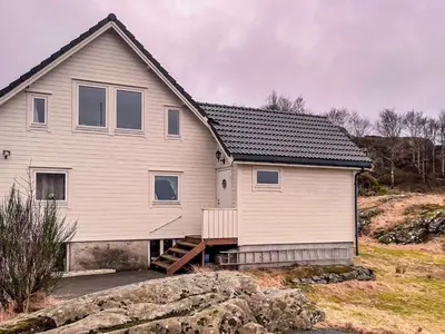 a house on a hillside with a house at 8 person holiday home in hauglandshella