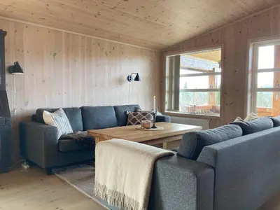 a living room with a blue couch and a table at 10 person holiday home in NORDTORPA in Nord Torpa