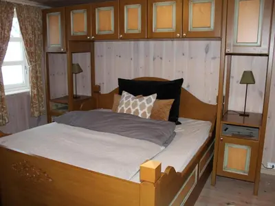 a bedroom with a bed with a wooden headboard at 10 person holiday home in NORDTORPA in Nord Torpa