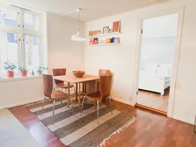 a dining room with a table and chairs at Cosy authentic apartment, only 60m from Bryggen! in Bergen