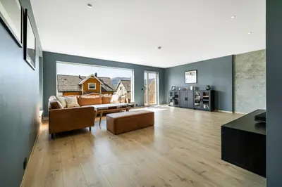 a living room with a couch and a table at House with outdoor area in Ålesund
