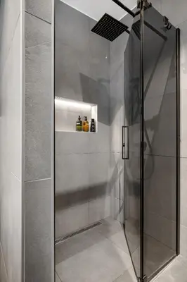 a shower with a glass door in a bathroom at House with outdoor area in Ålesund