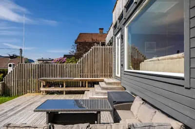 a patio with a table and a bench on a house at House with outdoor area in Ålesund