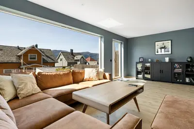 a living room with a couch and a table at House with outdoor area in Ålesund
