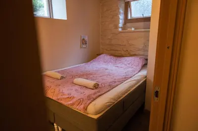 a small bed in a room with two pillows on it at Private Apartment in Bergen in Bergen