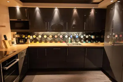 a kitchen with black cabinets and a sink at Private Apartment in Bergen in Bergen