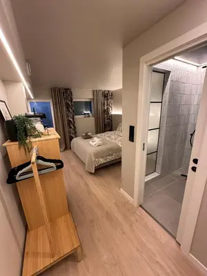 a bedroom with a bed and a walk in shower at Newly Renovated Rom Bergen Fana in Bergen